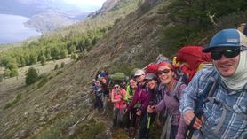 Group members on a mountainside hike